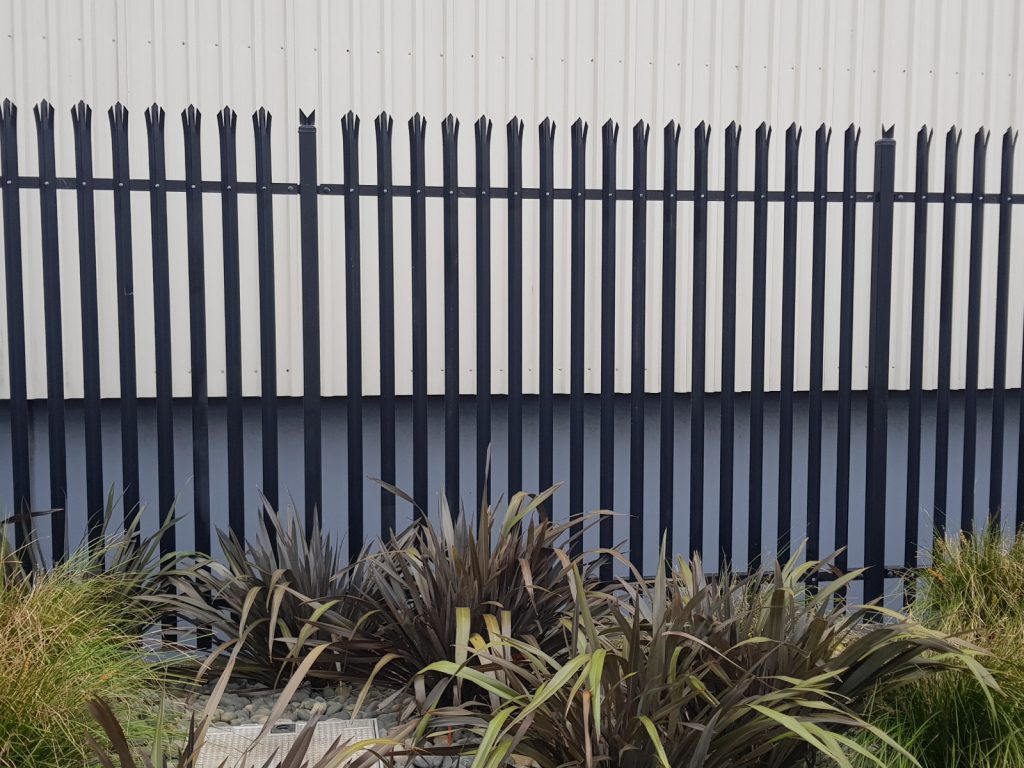 Steel bollards and vehicle barrier separating a roadway from a footpath